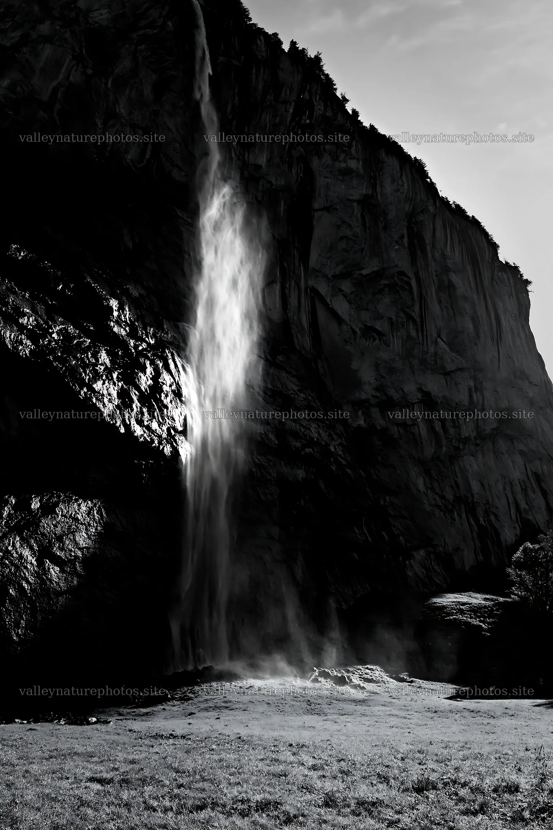 Light rays through Lauterbrunnen Valley meadow and waterfall – nature photography 6480x9722