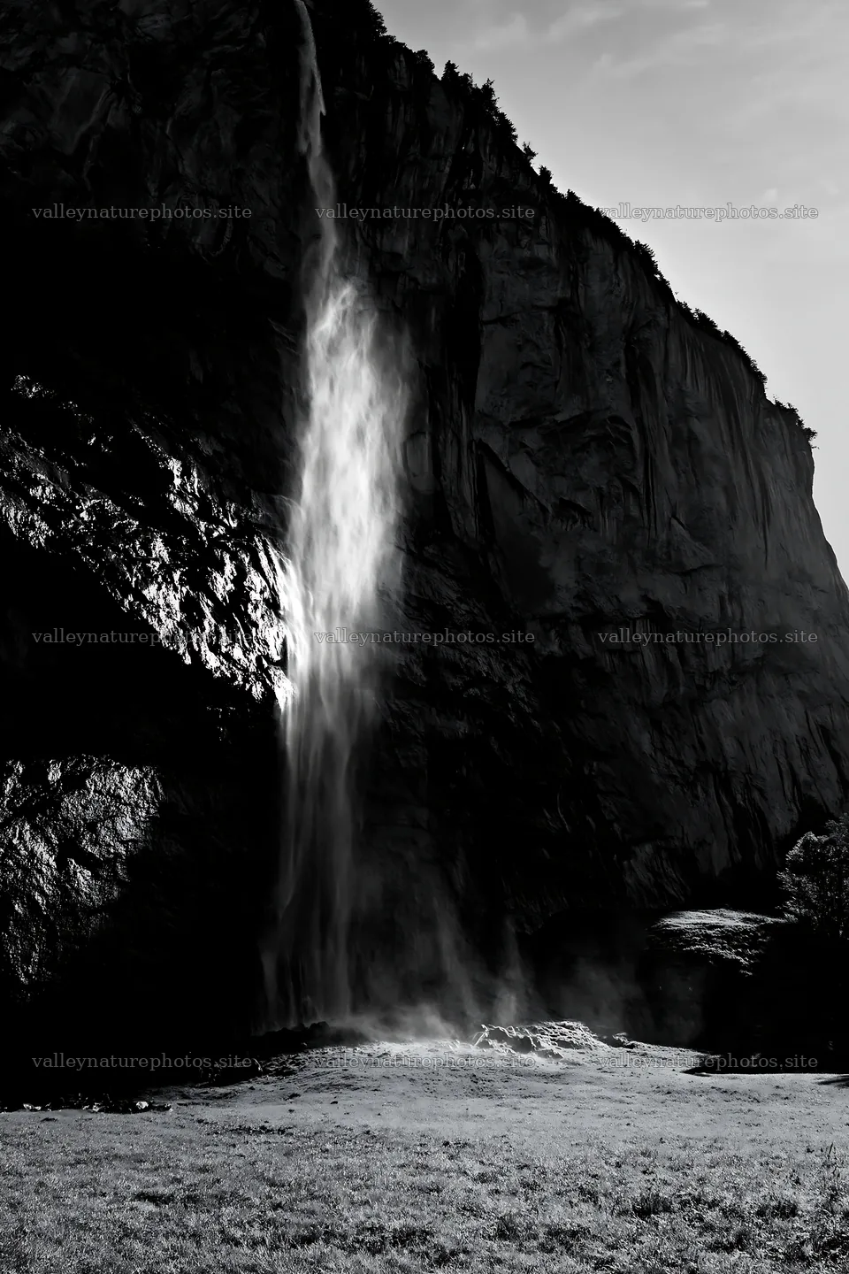 Light rays through Lauterbrunnen Valley meadow and waterfall – nature photography 6480x9722