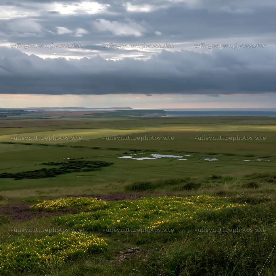 Cloudy chalk meadow view with water and land at dusk – nature photography 7938x7938