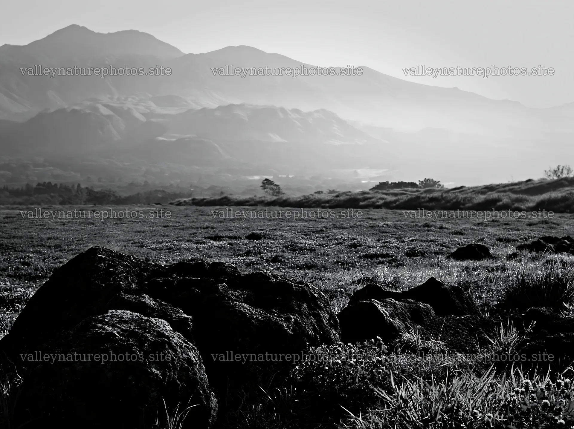 Kumamoto volcanic meadow with dark rocks and mountains – nature photography 9174x6866