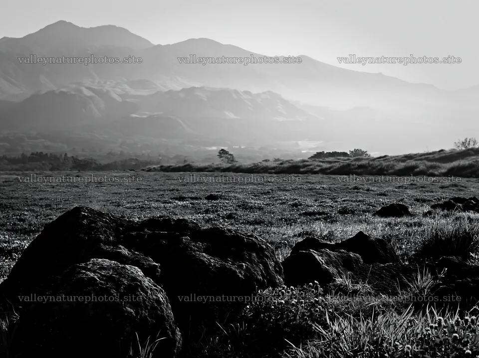 Kumamoto volcanic meadow with dark rocks and mountains – nature photography 9174x6866