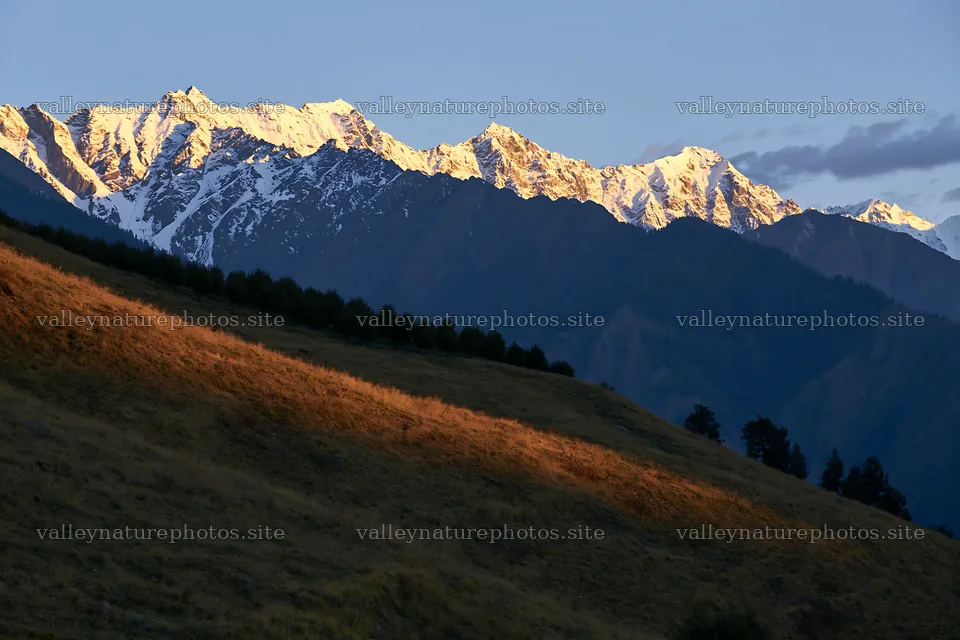 Sunset over apple meadow with mountains in the background – nature photography 9722x6480