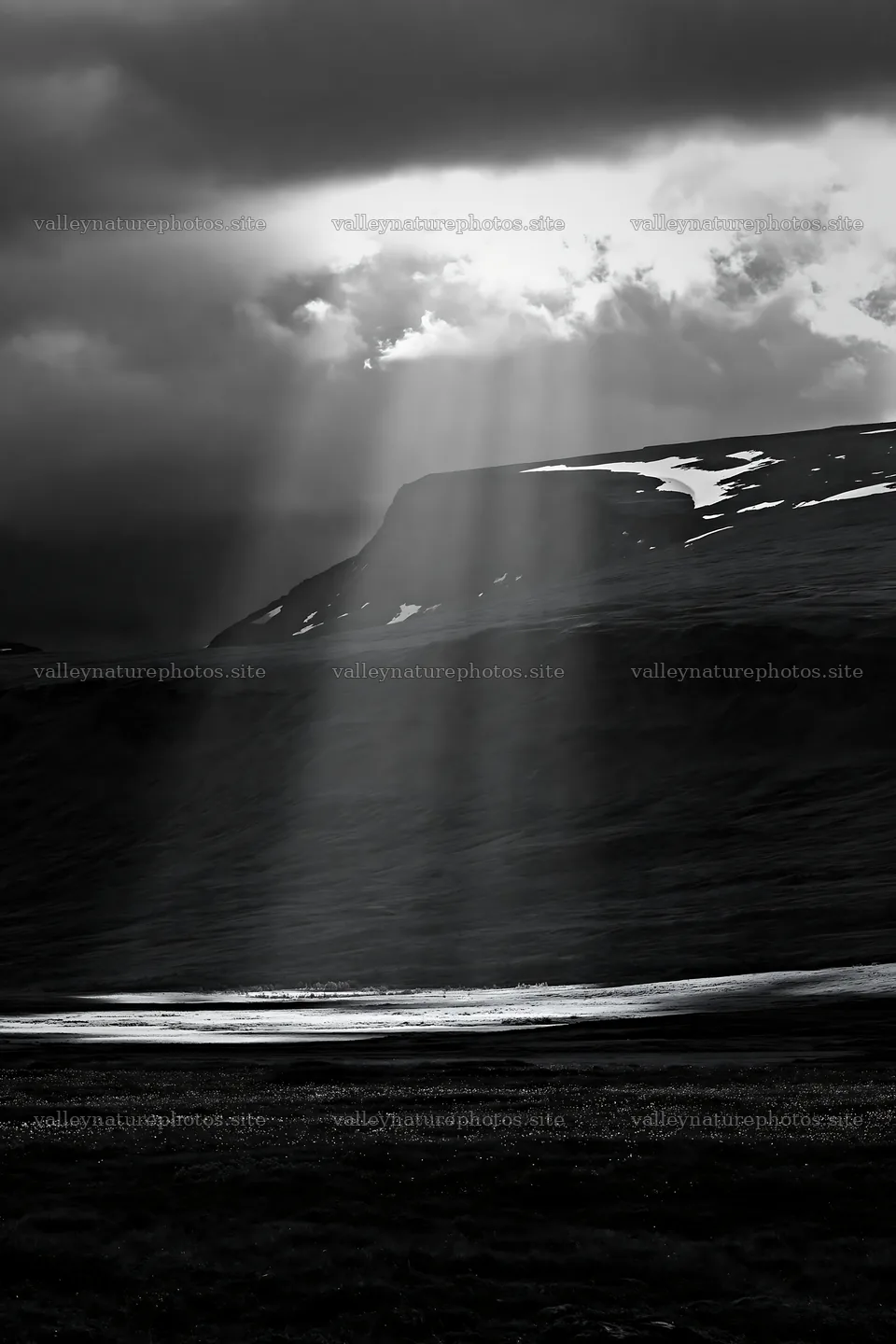 Sunrays shining on mountain meadow under cloudy sky – nature photography 6480x9722
