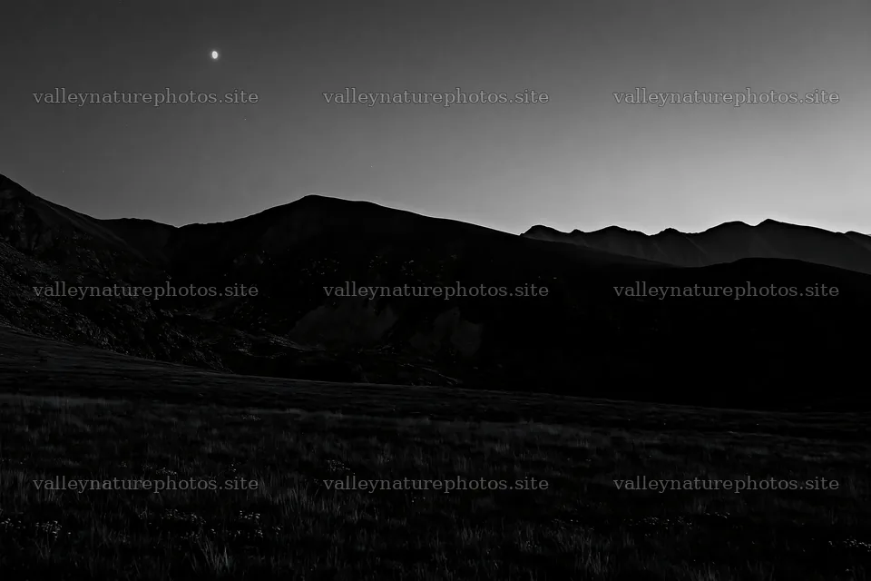 Moonrise over a meadow with mountains in the background – nature photography 9722x6480