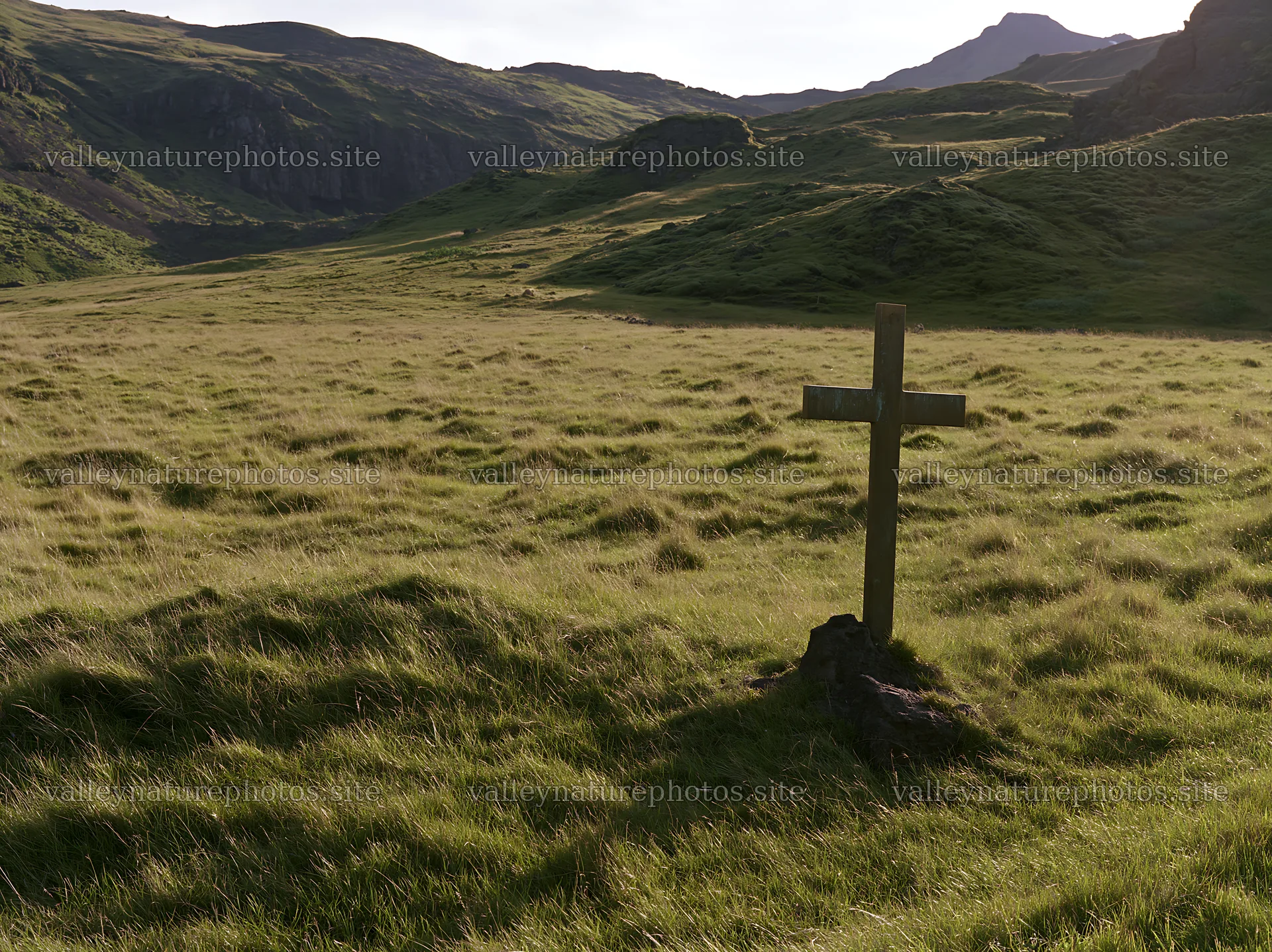 Bronze Christian cross in meadow during Christmas season – nature photography 9174x6866