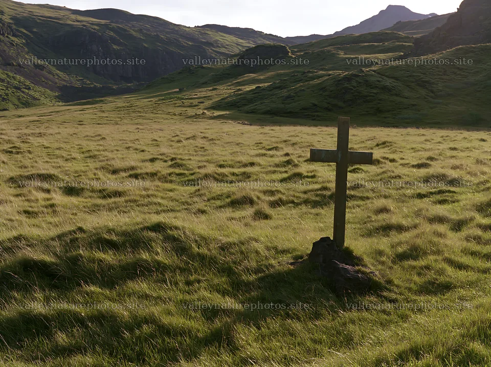 Bronze Christian cross in meadow during Christmas season – nature photography 9174x6866