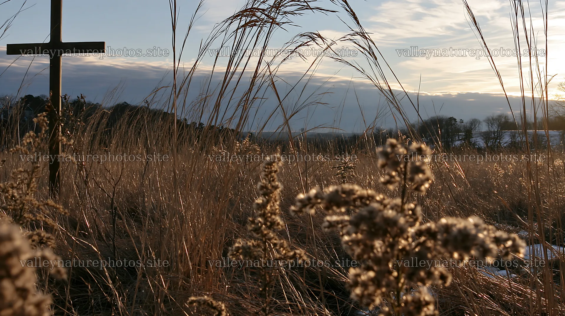 Bronze Christian cross in a Christmas meadow landscape – nature photography 10608x5938