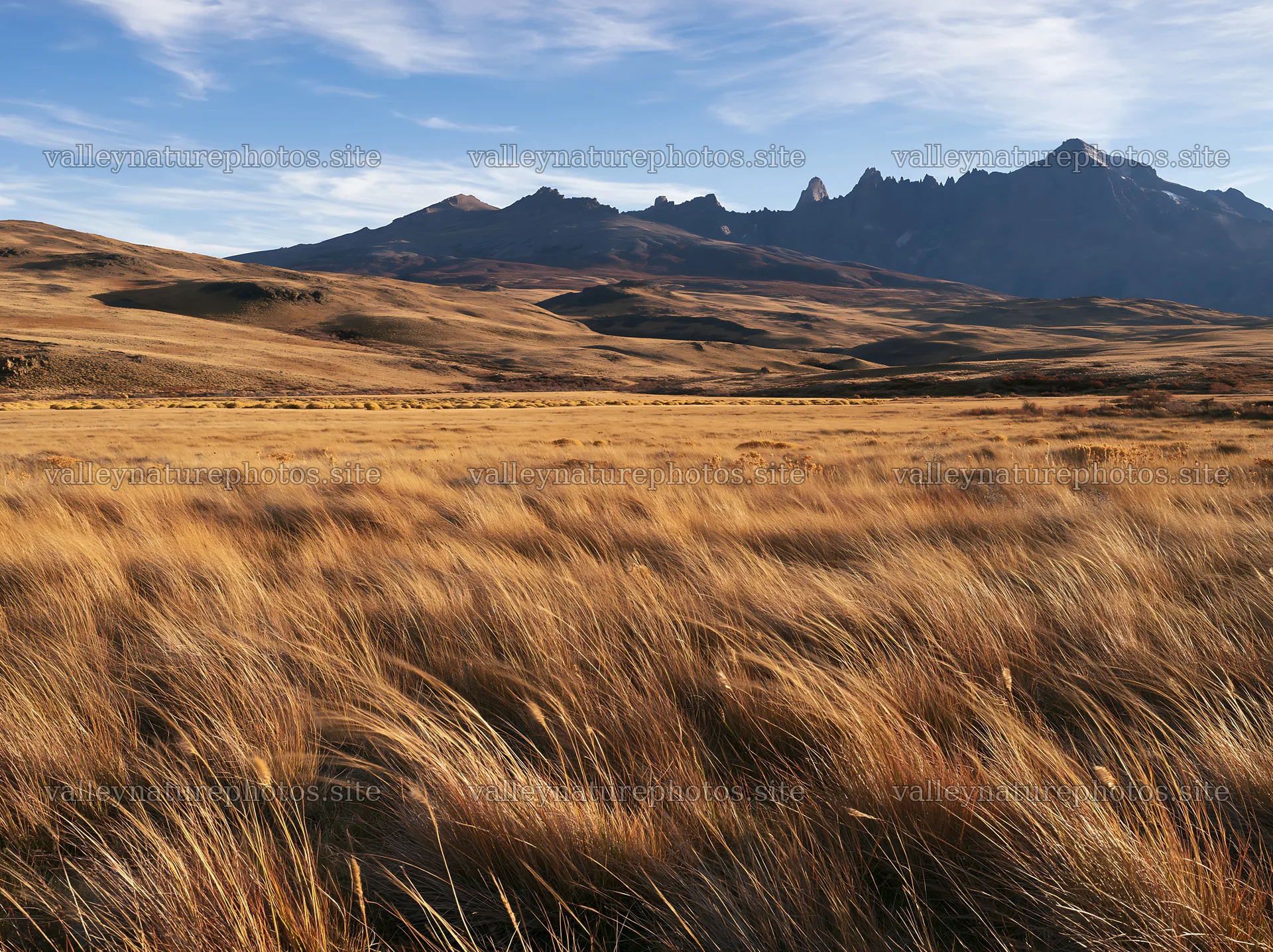 Rolling valley meadow under blue sky and mountains – nature photography 9174x6866