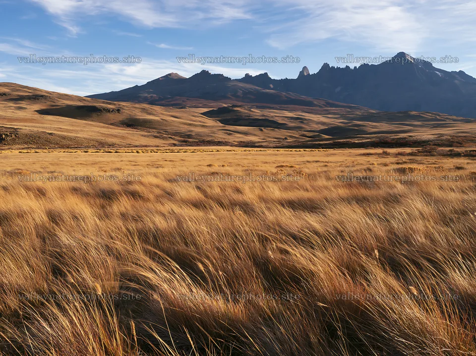 Rolling valley meadow under blue sky and mountains – nature photography 9174x6866