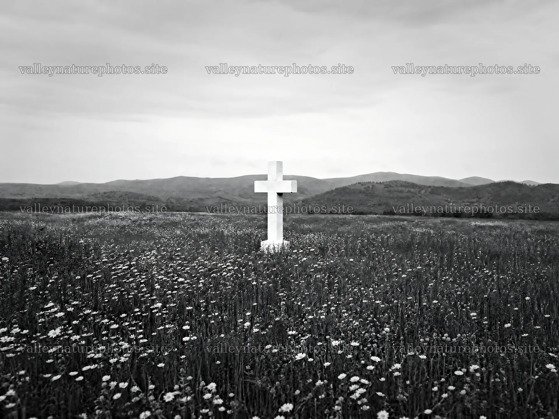 Marble Christian cross in a meadow with distant hills – nature photography 9166x6874
