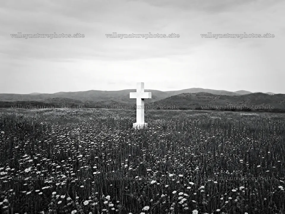 Marble Christian cross in a meadow with distant hills – nature photography 9166x6874