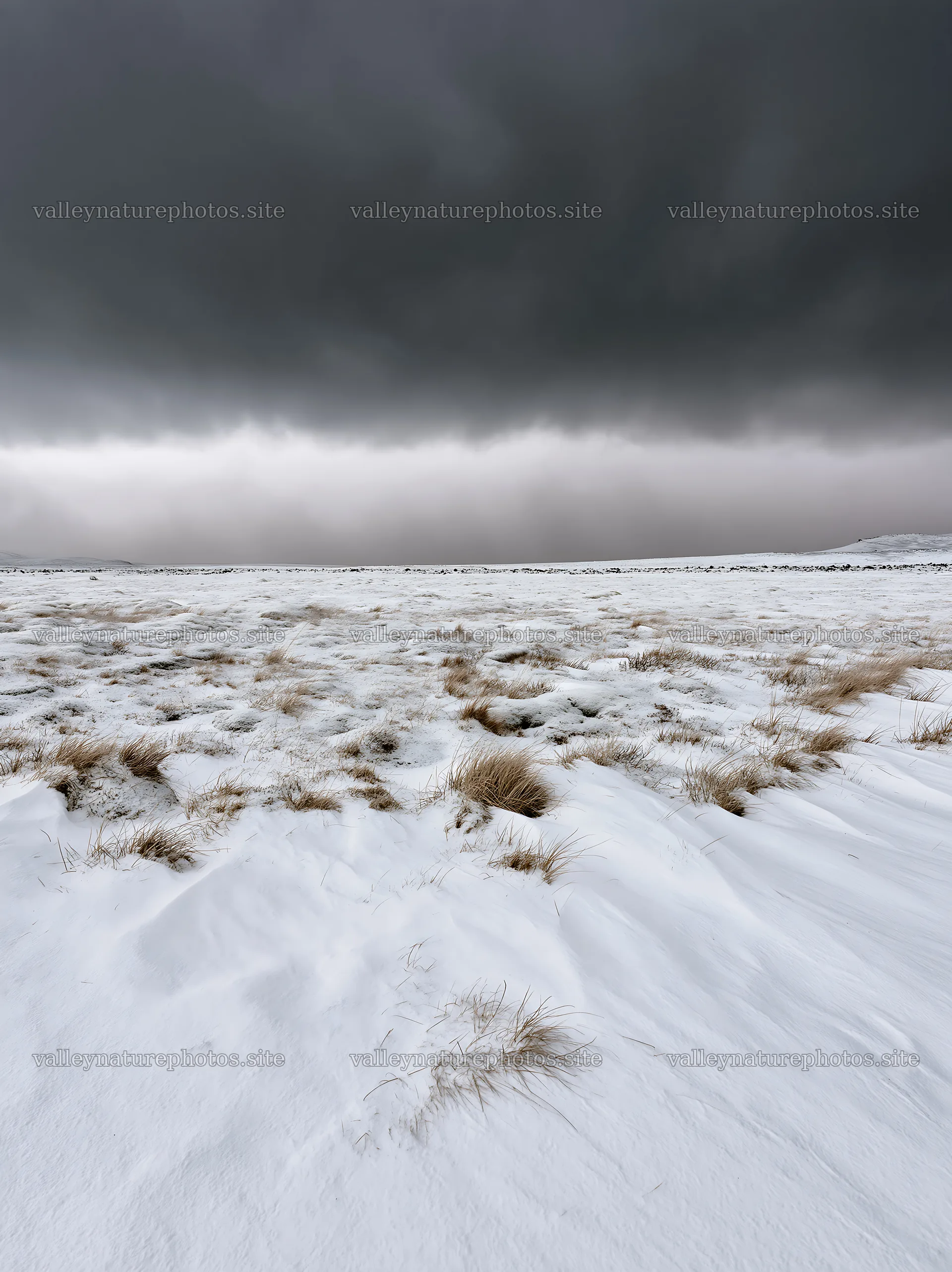 Snowy highland meadow with dark clouds above – nature photography 6866x9174