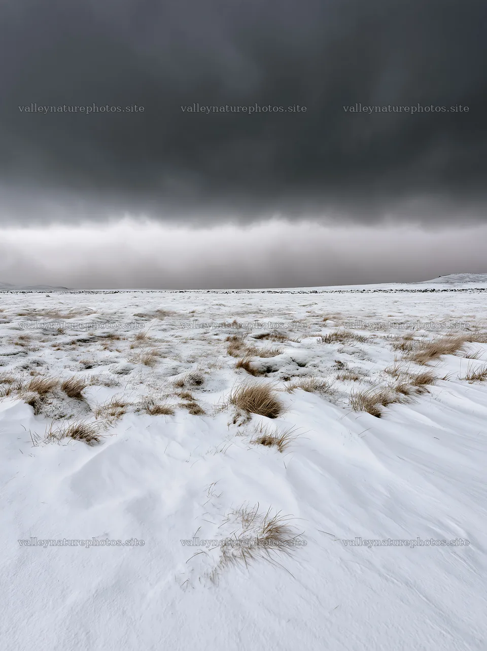 Snowy highland meadow with dark clouds above – nature photography 6866x9174