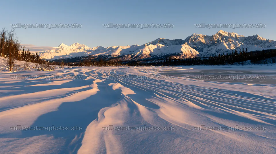 Snowbound meadow with mountains at sunset – nature photography 10608x5938